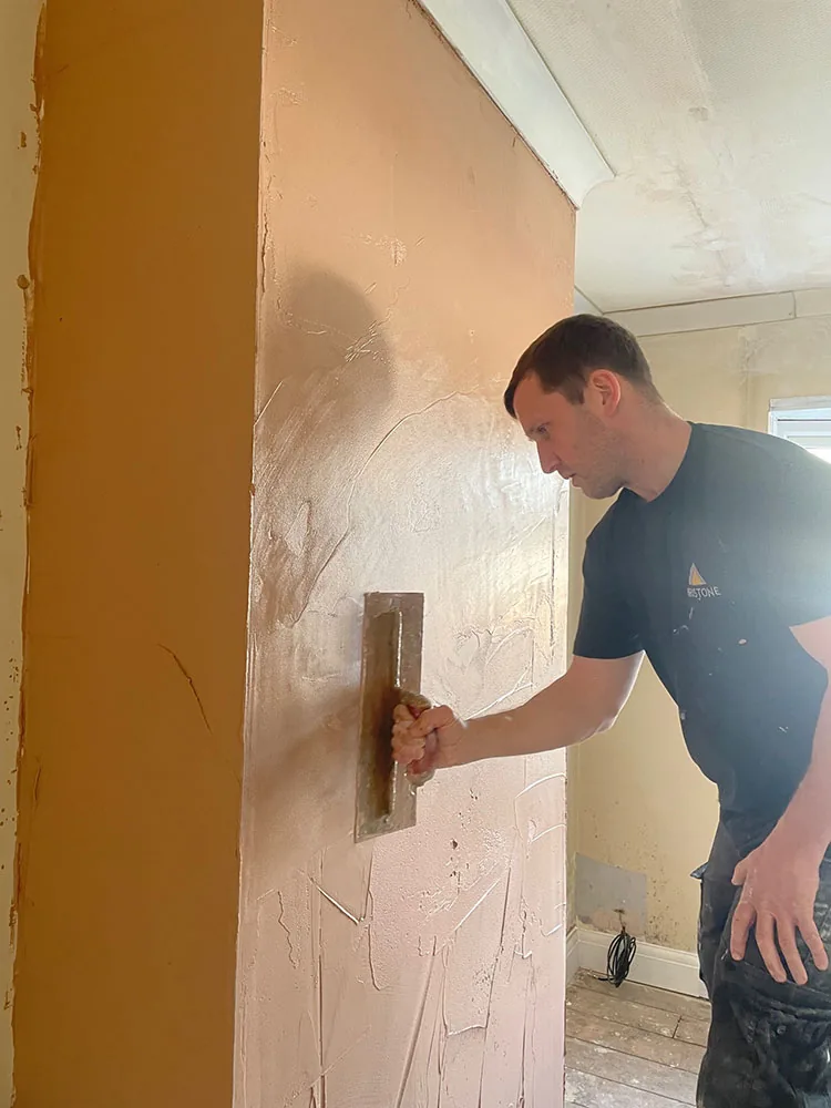 Bristone builder plastering an internal wall